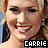 six pixelated images showing a smiling woman with blonde hair and earrings, each labeled 'CARRIE' in different colored text