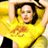 Pixelated image of a person in yellow shirt with orange graphic, arms raised above head against dark background.