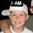 A pixelated image shows a person wearing a white cap and tank top with text overlays reading 'I AM' and 'Optimus Prime' against a dark background.