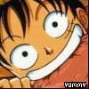 Close-up of an anime character with wide eyes, orange hair, and a broad grin, wearing an orange shirt with a white collar.