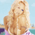 Static pixelated image of a blonde woman in swimwear against a beach background with water and sky visible.