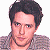 A 50x50 pixel AIM buddy icon featuring a celebrity mugshot-style image with green text overlays on a white background, part of an animated contact sheet.