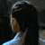 Animated sequence showing a character with long dark hair in profile views transitioning to front-facing, alongside a 'Tomb Raider' logo.