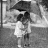 A black-and-white animated sequence shows a person holding an umbrella in the rain, with changing text overlays forming a phrase.