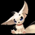 Pixelated white creature with large blue eyes, prominent ears, and a red collar against a black background.