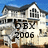 A house with a blue sky background, featuring 'OBX 2006' text overlaid in black.