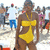 A woman in a yellow bikini stands on a beach with a crowd in the background, shown in three with slight variations in pose and background elements