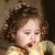A 50x50 pixel animated buddy icon featuring a child with curly brown hair on the left and green text reading "Original Icons .com" on the right against a dark background.