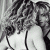 Black-and-white pixelated image of a woman with curly hair wearing a sleeveless top, next to green text reading 'Original Icons .com' on a solid background.