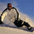Pixelated static image of a person skiing on snow with blue sky background, rendered in low-resolution 256x256 pixels.