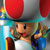 Pixelated character with red and gray hat, brown skin, black eye, mustache, white shirt, blue sleeves, holding object against colorful background.