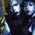 Four distinct facial expressions of a single figure with pale blue skin, dark hair, and red lips displayed in a