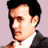 Static pixelated image of a person's face and upper torso in profile view against light purple background.