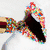 A mouth with colorful sprinkles on lips and teeth, transitioning to a rainbow gradient mouth with visible teeth.