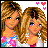 Pixel art collage of two blonde women in coordinated outfits with heart symbols and text reading "I LOVE MY SISTER" on blue background.
