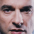 A pixelated close-up of a person's face showing eyes, nose, mouth, and part of the forehead with visible skin texture and subtle color variations.