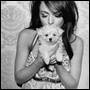 Black-and-white image of a woman holding a small dog, rendered in low-resolution pixel art style with visible dithering and anti-aliasing on edges.