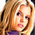 Static pixelated image of a person with light brown hair and purple clothing against a white background.