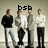 Four pixelated figures stand in a row against a muted background with 'bsb' text above them; the central figure holds an object resembling a microphone.