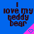Blue background with dark brown text reading "I love my teddy bear" and a pink triangular shape containing a pixelated heart.