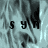 Pixelated grayscale image with repeated 'syn' text overlays on a textured background, showing partial visibility of the right side.