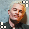 six shows a person with light hair in a dark shirt against a textured blue background, with pixelated text and block patterns changing