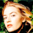 Static 48x48 pixel icon showing a close-up of a person with light brown hair and fair skin against a dark background with green foliage elements.