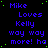 Blue pixelated text on black background reads "Mike Loves Kelly way way more! ha" in multiple with green dots scattered around