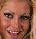 Pixelated close-up of a person's face showing eyes, nose, mouth, and light brown hair against a neutral background.