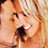 Pixelated close-up of a person's face with visible eyes, nose, and mouth against warm-toned background.