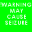 !WARNING MAY CAUSE SEIZURE text in pixelated font on four colored : green, gray, pink, and dark gray