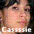 Pixelated image of a person with light skin and brown hair, wearing pink clothing against a dark background with white text reading 'Cassie' at the bottom.