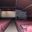 Pixelated static image showing a dark interior with a light rectangular section and pinkish lower area, likely a cropped section of a larger scene.