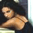Pixelated image of a person with dark hair and light skin, wearing a brown strap across the chest, positioned next to green text reading 'OriginalIcons.com' on a dark background.