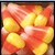 Pixelated image split into two sections: left shows candy corn in red, white, and yellow; right displays orange background with black text "I" above heart symbol and partial word "Halloween".