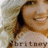 A pixelated image of a smiling woman with long light brown hair, wearing a white top and visible necklace.