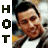 A pixelated image of a person in a jacket and white shirt with changing text on the left side.