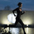 Pixelated figure in black athletic wear running on a reflective surface with a bright circular light behind them against a gradient sky.