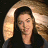 A 48x48 pixel buddy icon split into two frames showing a person with long hair and green text reading "Original Icons .com" on a dark background.