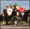Group of people standing outdoors with a bicycle, text overlays changing across frames.