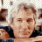 A pixelated image of a person with light brown hair and dark clothing, positioned next to green text reading 'OriginalIcons.com' on a solid background.