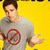 Pixelated image of a person in a gray shirt with a red prohibition symbol on chest, standing against bright yellow background with hand extended.