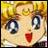 Pixelated close-up of a character's face with large blue eyes, red lips, and blonde hair, rendered in a low-resolution style.