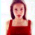 Pixelated image of a person with dark shoulder-length hair wearing a red sleeveless top against a light background.