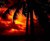 A static pixelated image of a stylized flame with orange and yellow hues against a dark background.