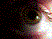 Pixelated image with dark background on left transitioning to multicolored pixel clusters on right, featuring scattered red dots and bright white light area.