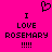 A bright pink background displays two identical pixelated text blocks with a heart symbol above them, each reading "I LOVE ROSEMARY !!!!" in black block letters.
