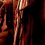 A pixelated image of a person with long brown hair and a red bandana, shown in three where the head shifts slightly left to right