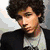 Four distinct pixelated images of a young man with dark curly hair in various poses and clothing, arranged in a