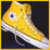 Yellow high-top sneaker with white sole and blue eyelet, displayed against dark background with yellow border.